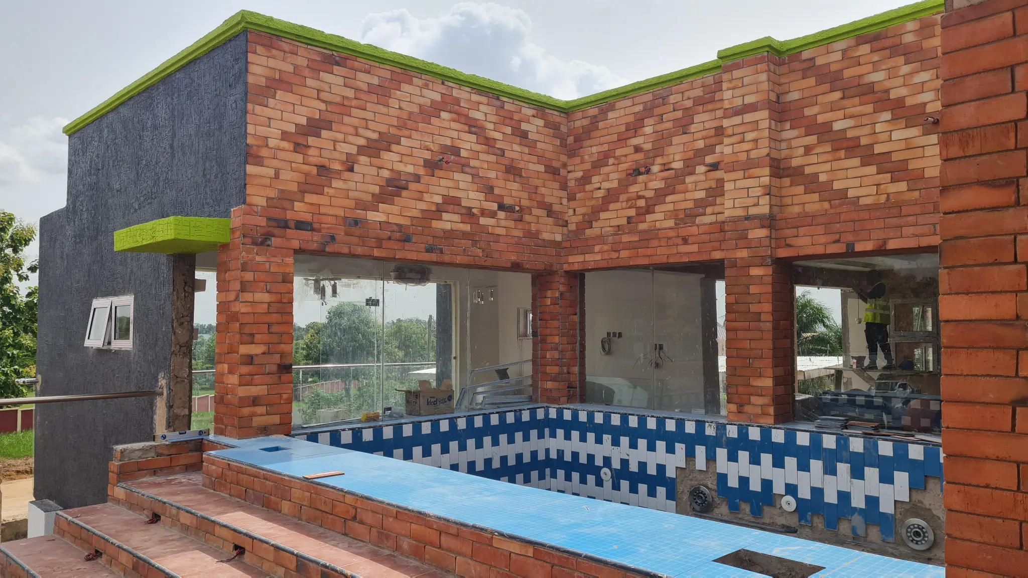 Luxury burnt clay brick facade with pool — Bricmates Ghana